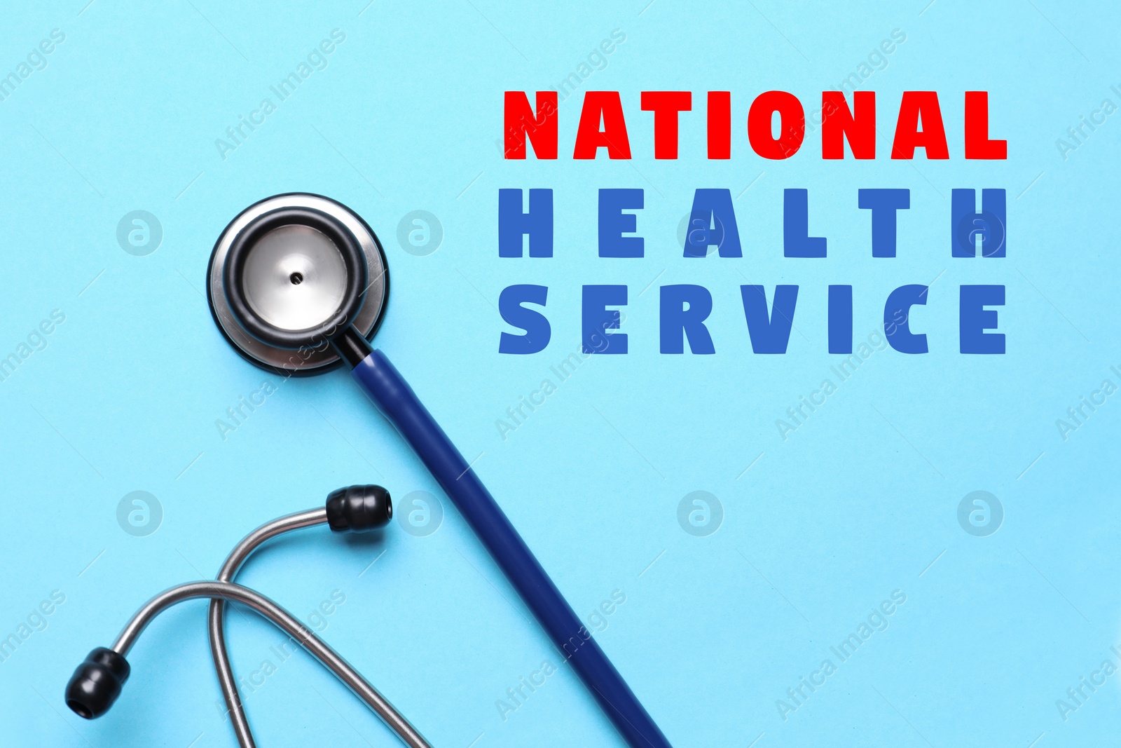 Image of National health service (NHS). Stethoscope and text on light blue background, top view