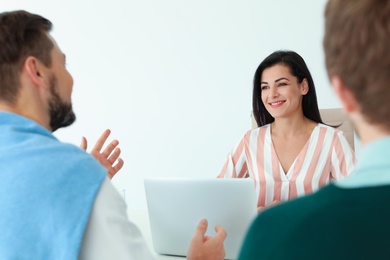 Photo of Human resources manager conducting job interview with applicants in office