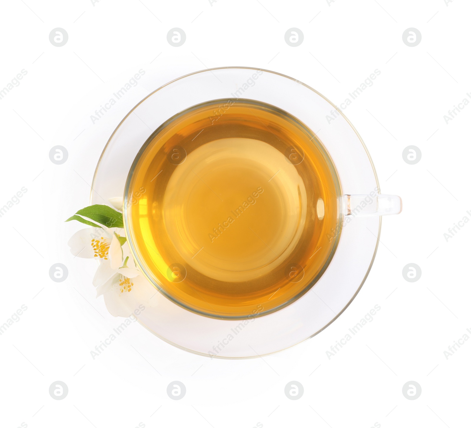 Photo of Glass cup of aromatic jasmine tea and fresh flowers on white background, top view