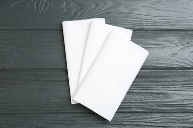 Photo of Clean napkins on grey wooden table, flat lay