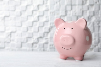 Photo of Pink piggy bank on white table. Money saving