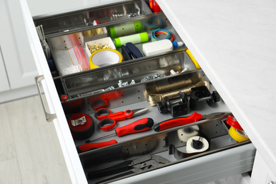 Set of instruments in open desk drawer indoors