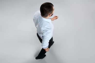 Photo of Man in formal clothes on grey background, above view