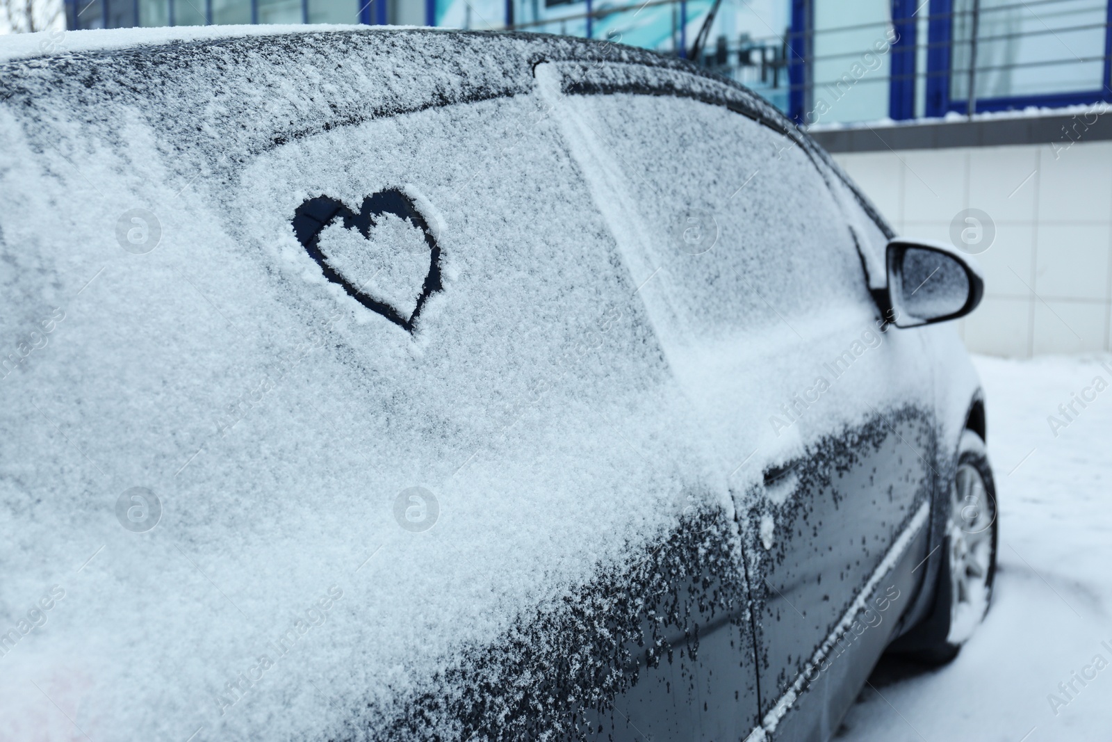 Photo of Heart drawn on car covered with snow outdoors. Space for text