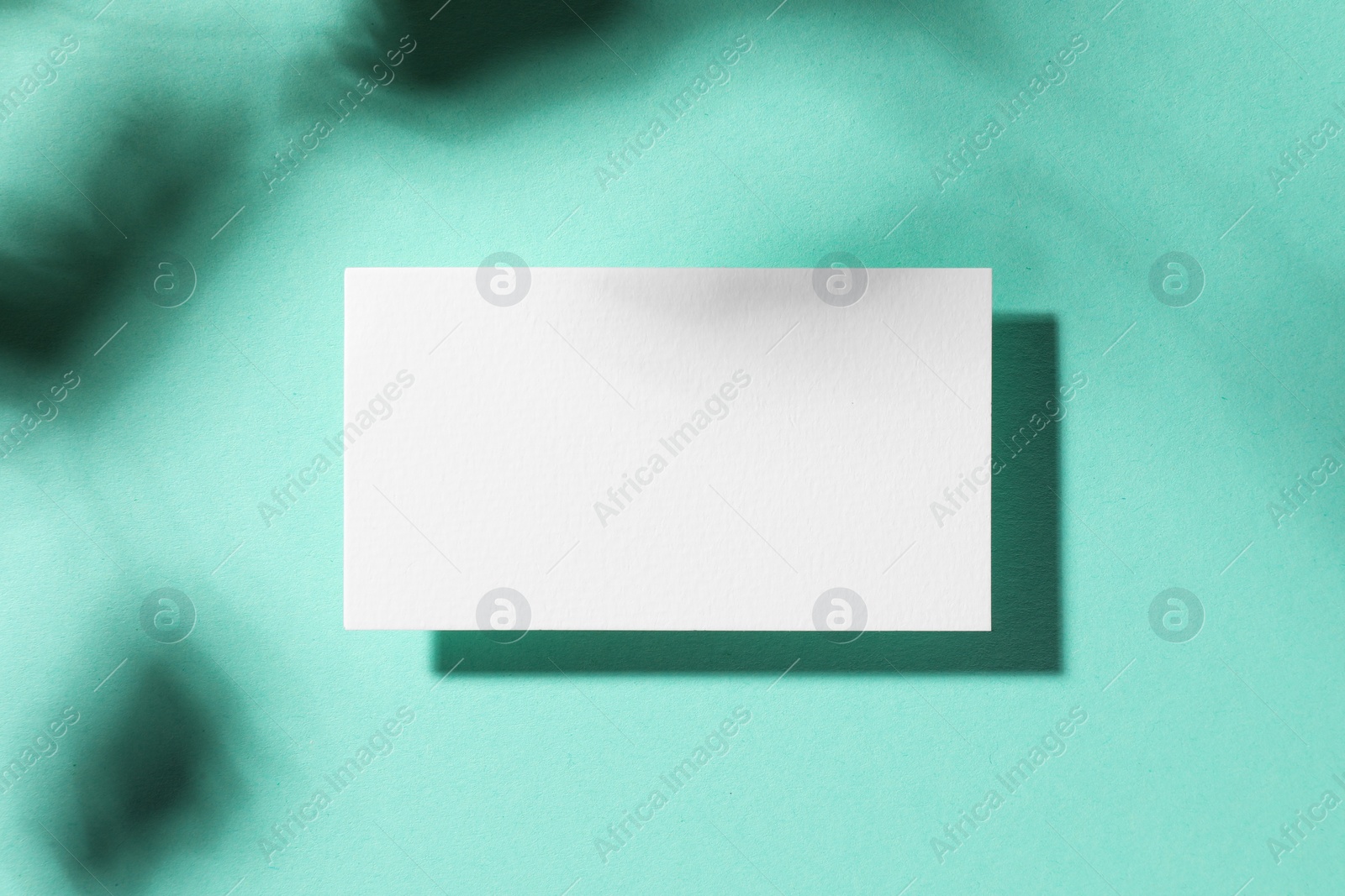 Photo of Empty business card on light blue background, top view. Mockup for design