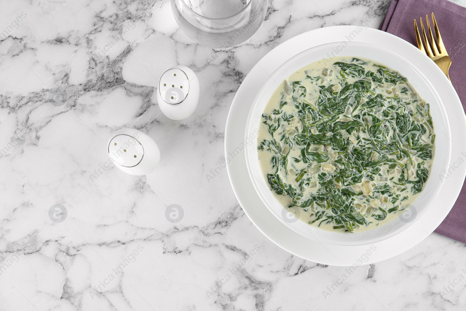 Photo of Tasty spinach dip on white marble table, flat lay