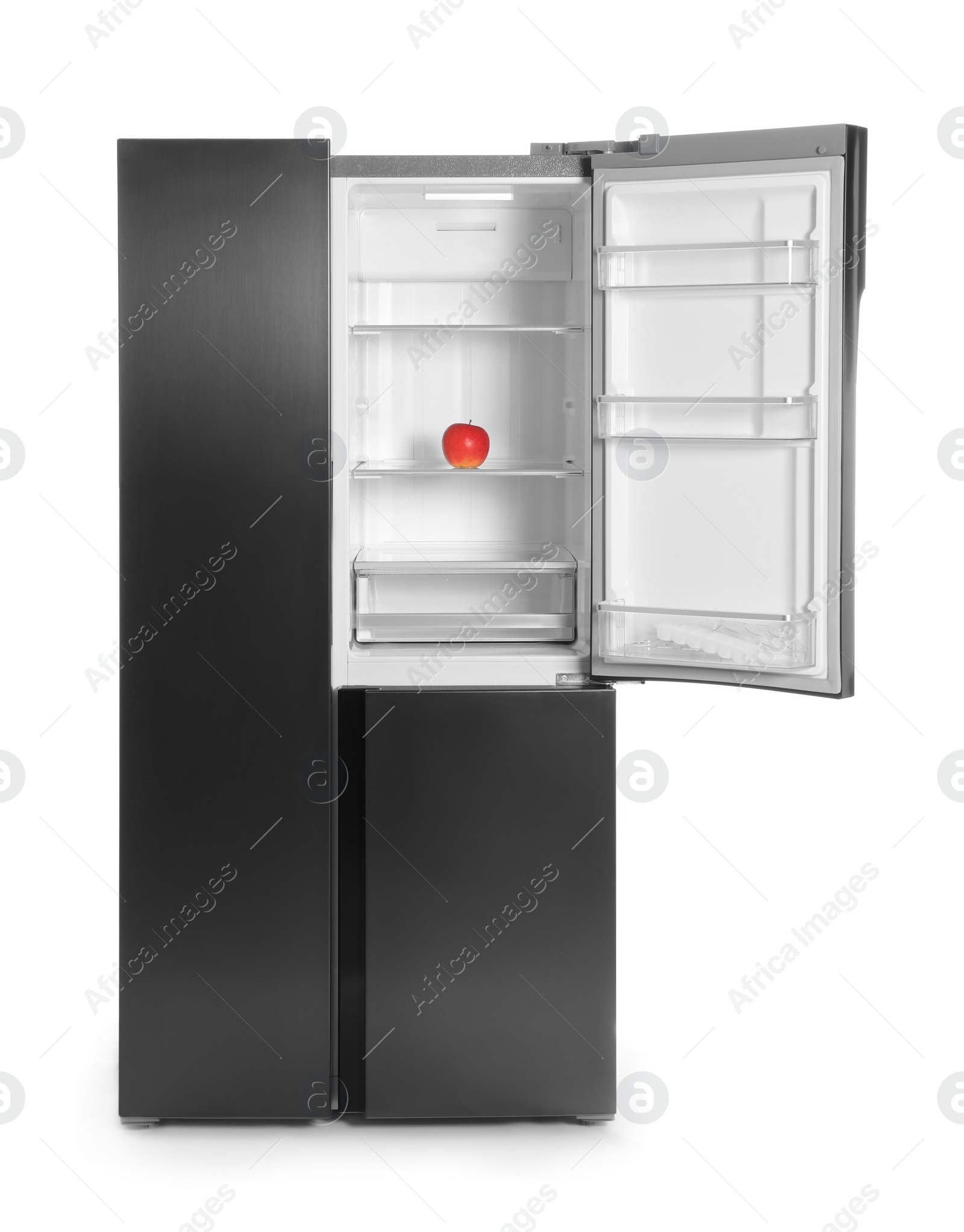 Photo of Modern refrigerator with red apple isolated on white