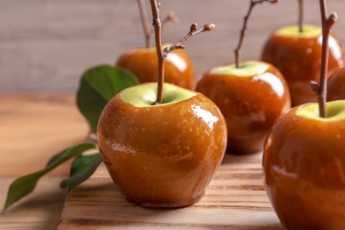 Photo of Delicious green caramel apples on table