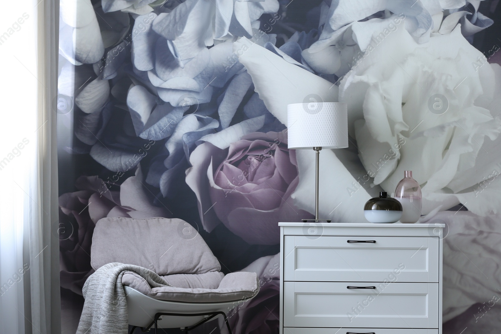 Photo of Stylish chest of drawers near painted wall in living room