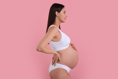 Photo of Beautiful pregnant woman in stylish comfortable underwear on pink background