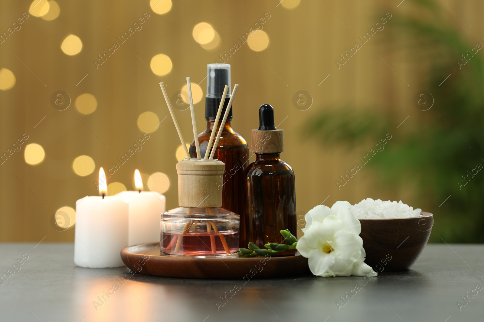 Photo of Composition with different spa products and burning candles on light grey table