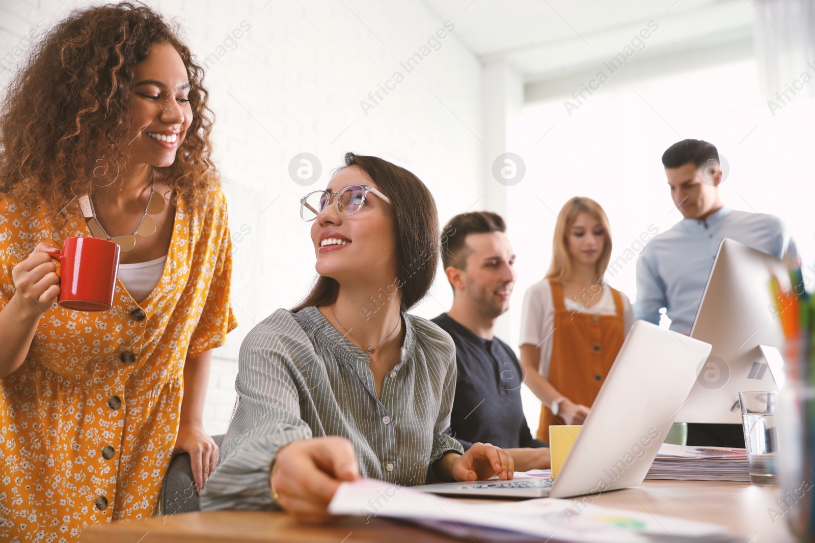 Photo of Team of professional designers working in office