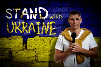 Image of Journalist near wall painted in colors of Ukrainian flag with words Stand With Ukraine