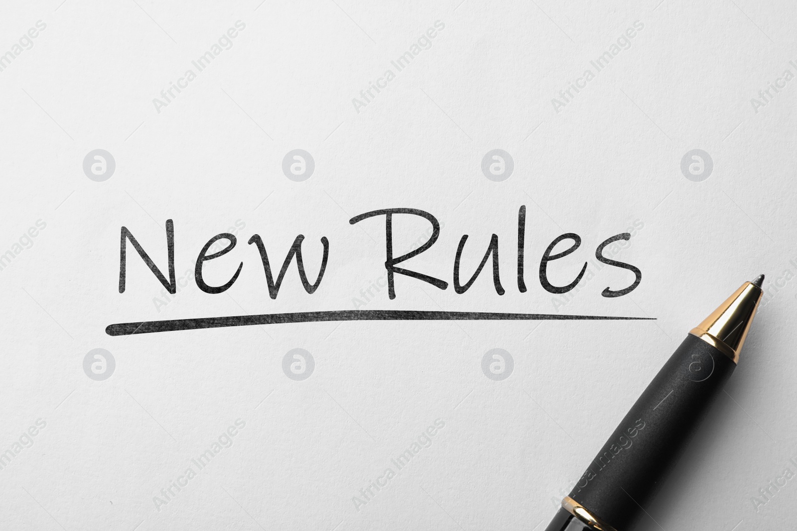 Image of Written text NEW RULES and pen on white background, top view