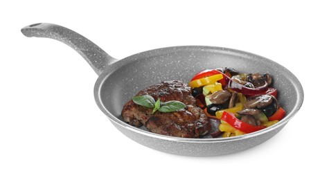 Photo of Tasty fried steak with vegetables in pan isolated on white