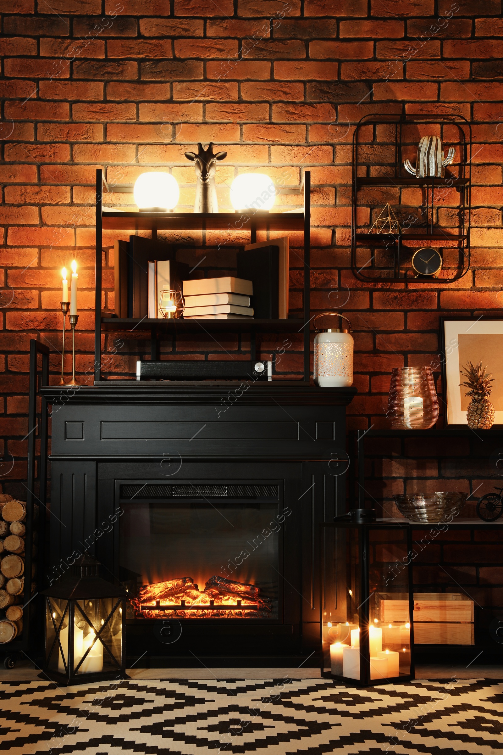 Photo of Beautiful fireplace and different decor in living room at night. Interior design