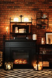 Beautiful fireplace and different decor in living room at night. Interior design