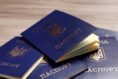 Many Ukrainian internal passports on table, closeup