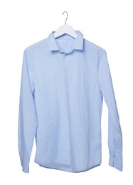 Photo of Crumpled light blue shirt on hanger against white background