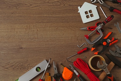 Photo of Flat lay composition with repair tools on wooden table, space for text