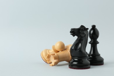 Photo of Different chess pieces on light background. Space for text