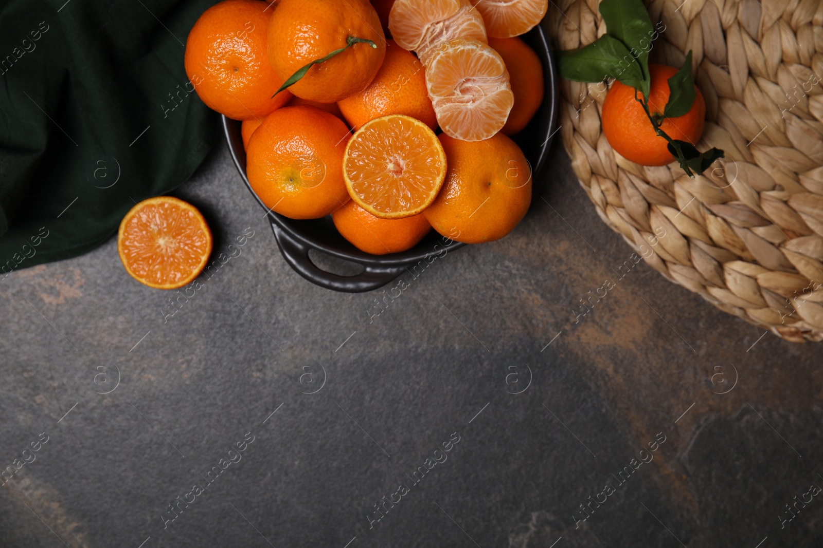 Photo of Fresh juicy tangerines on black table, flat lay. Space for text