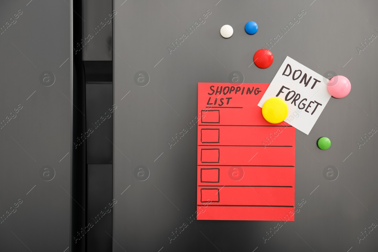 Photo of Note with phrase DON'T FORGET, shopping list and magnets on refrigerator, closeup