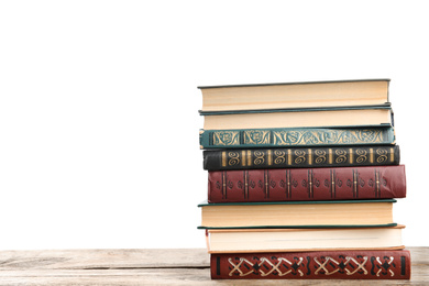 Photo of Stack of old vintage books on wooden table against white background