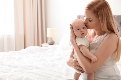 Photo of Mother with her little baby in bedroom