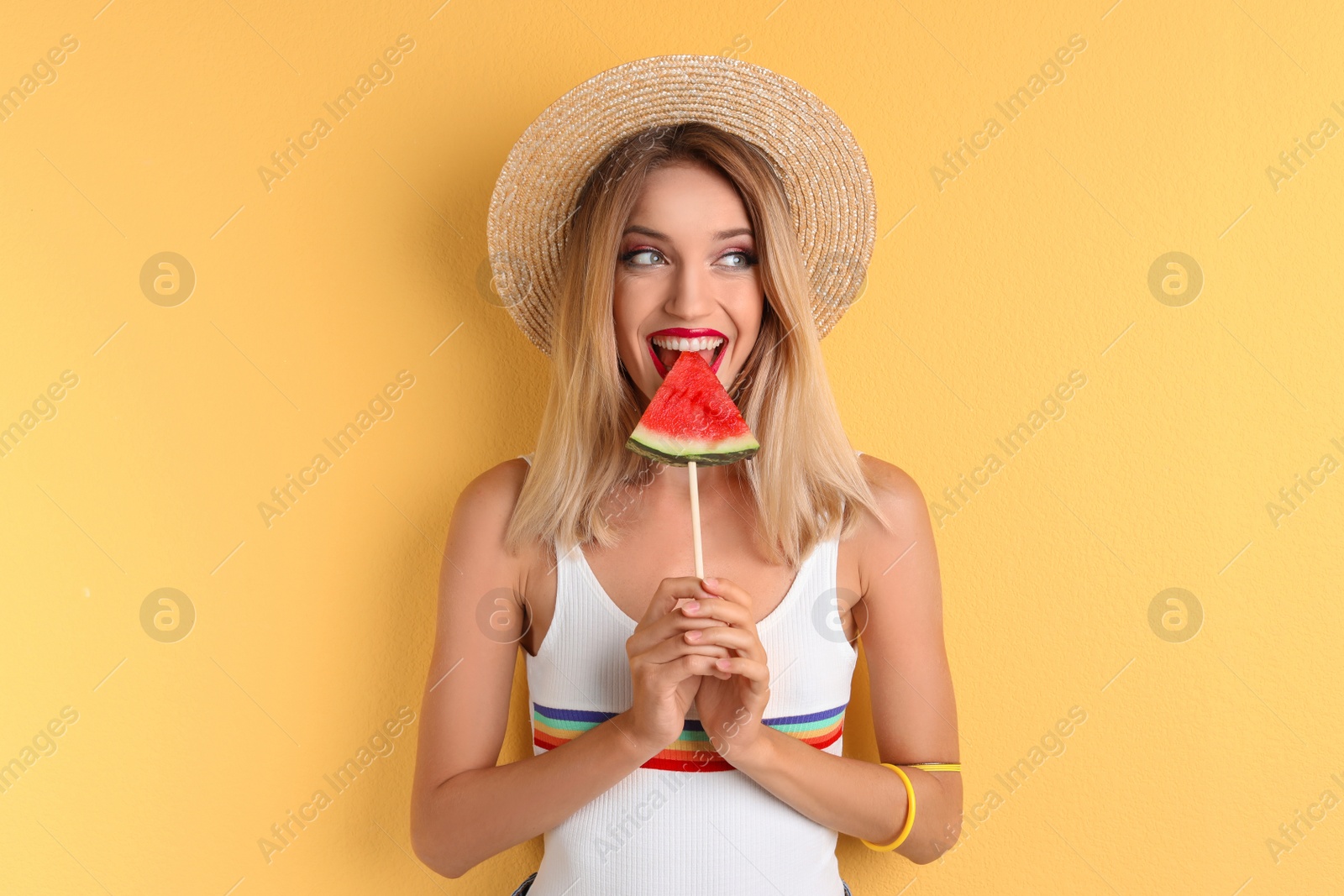 Photo of Pretty young woman with juicy watermelon on color background