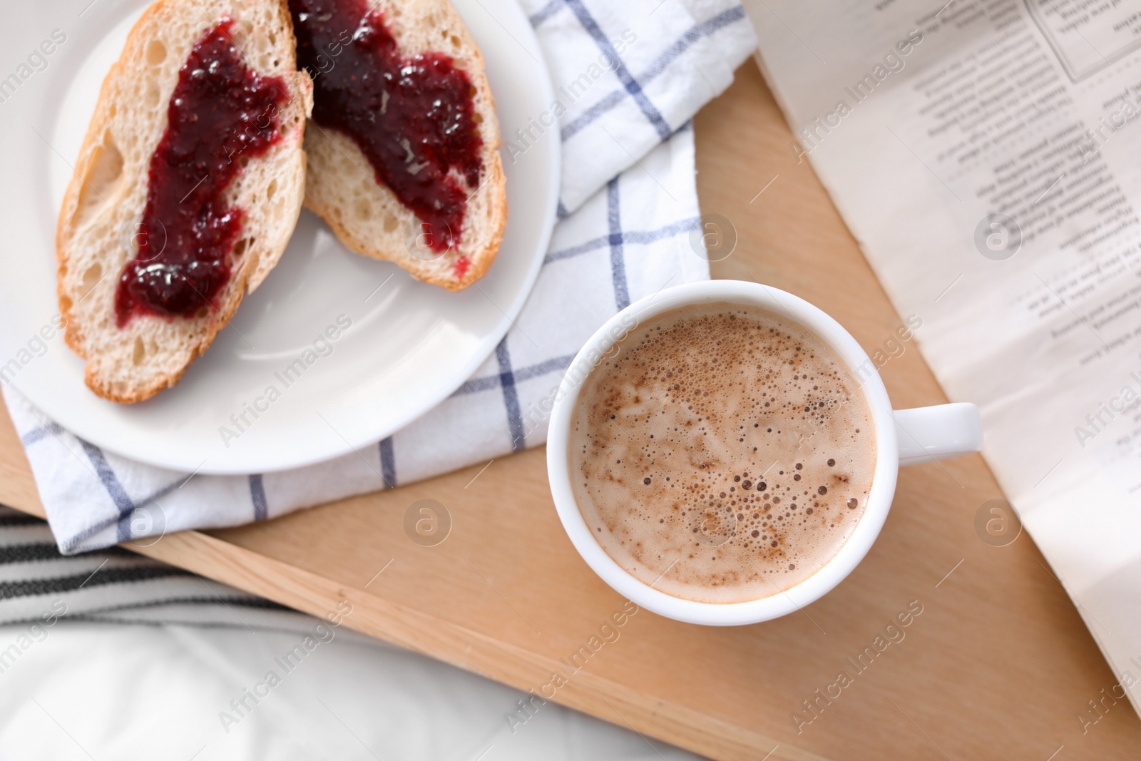 Photo of Morning coffee and sandwiches on tray in bedroom, flat lay