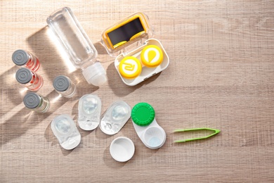 Contact lenses and accessories on wooden table