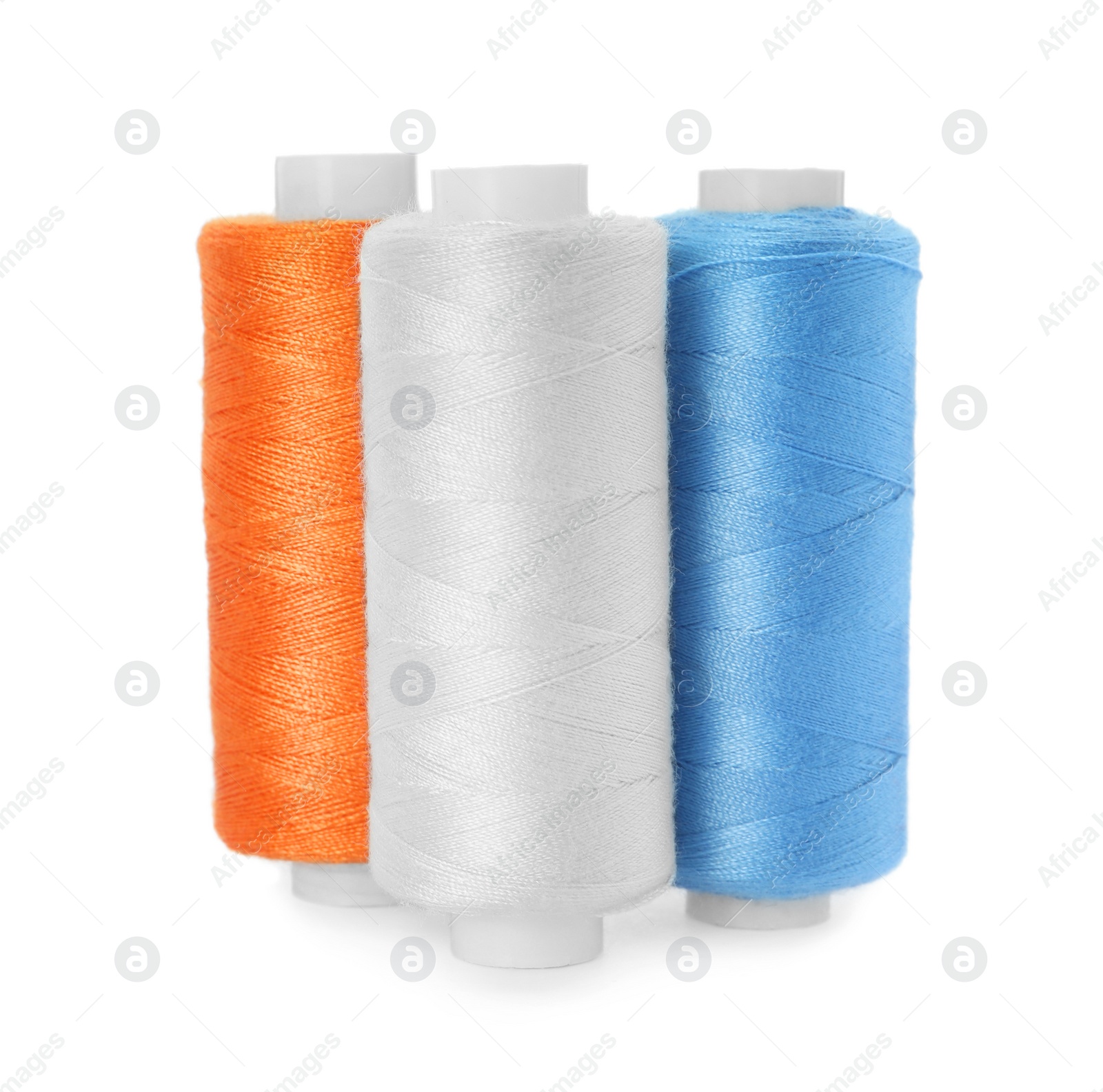 Photo of Different colorful sewing threads on white background