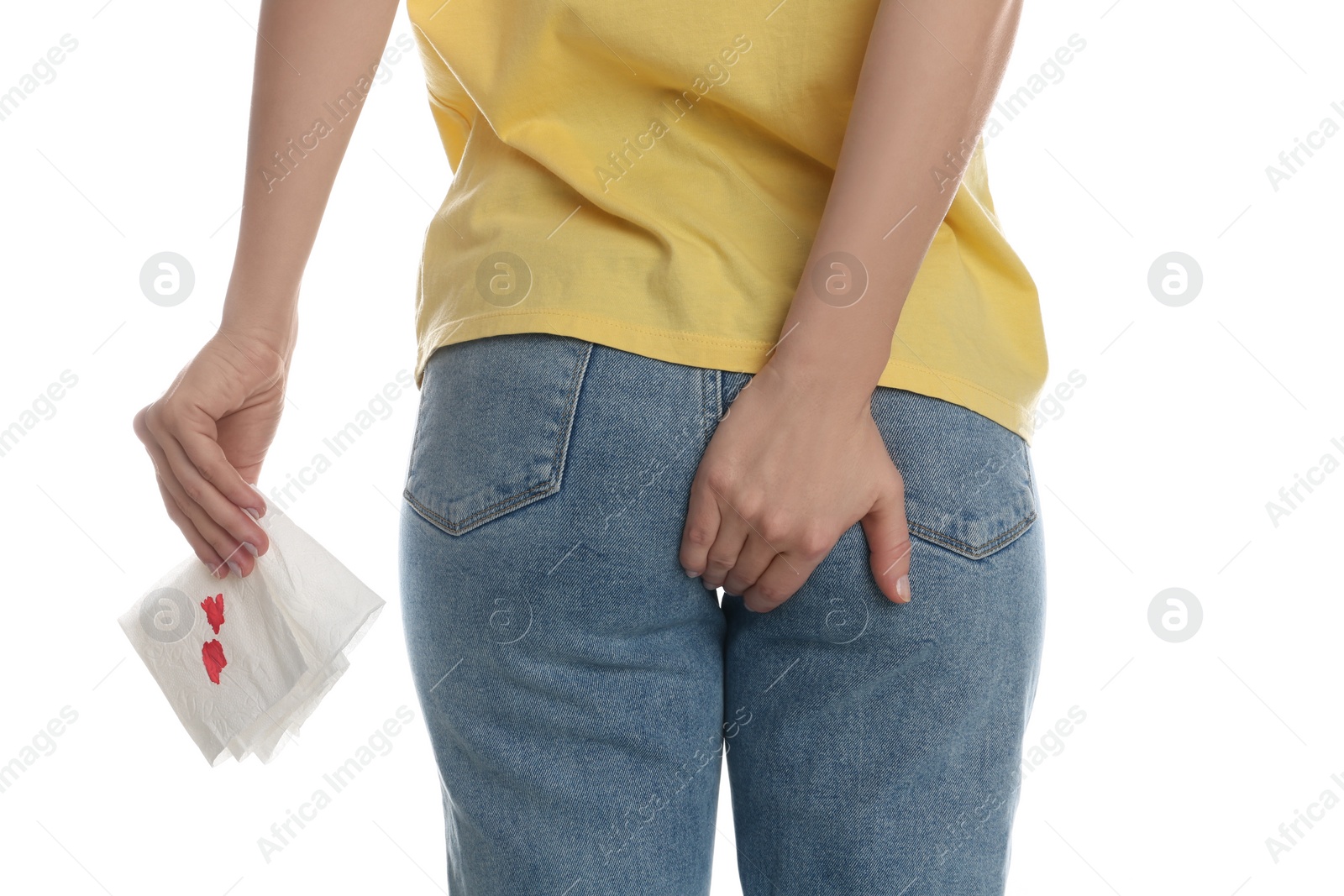 Photo of Woman holding toilet paper with blood stain on white background, closeup. Hemorrhoid concept