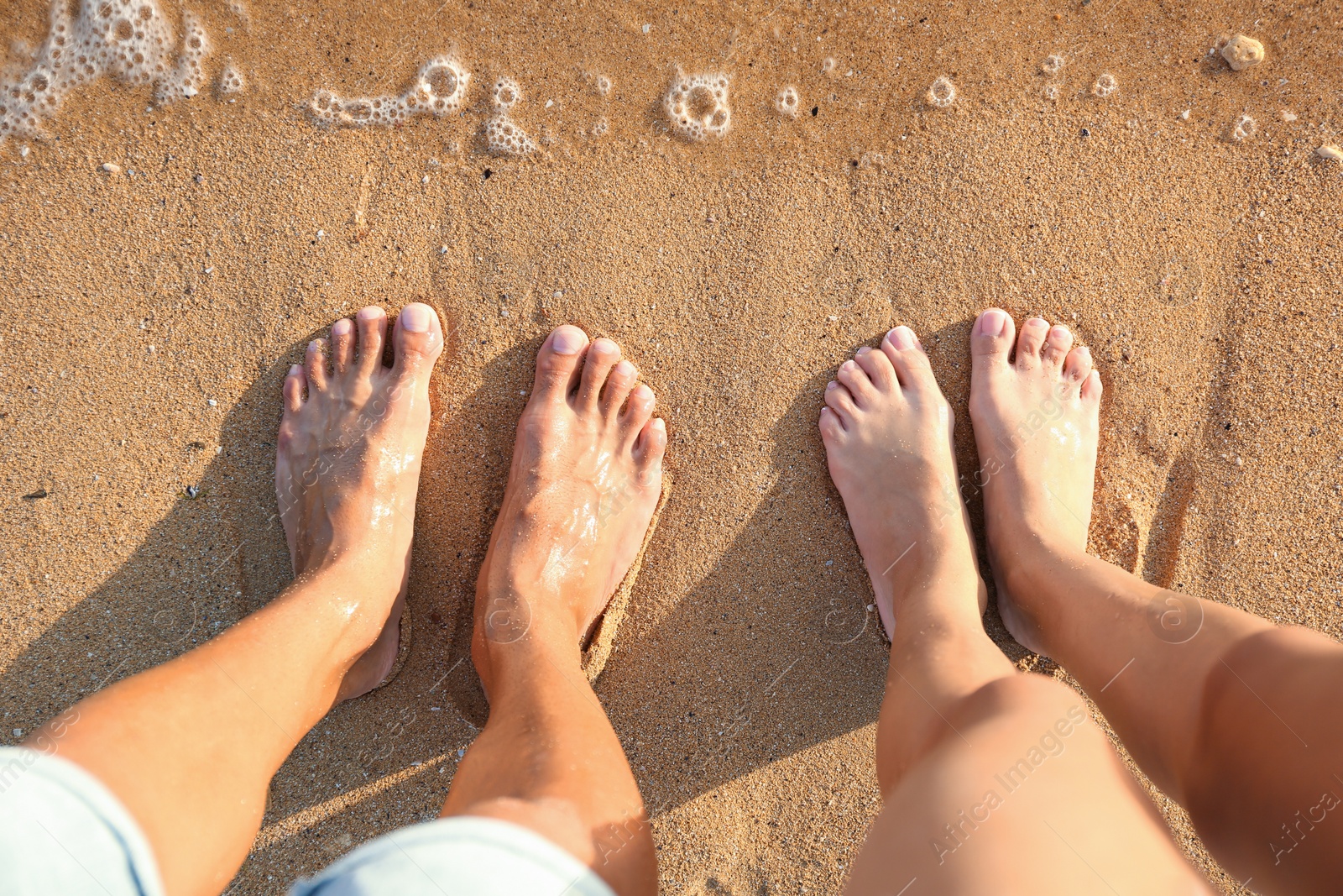 Photo of Young couple resting together at beach, top view.