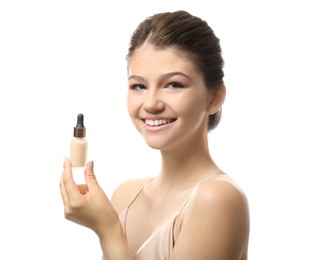 Beautiful girl with bottle of foundation on white background