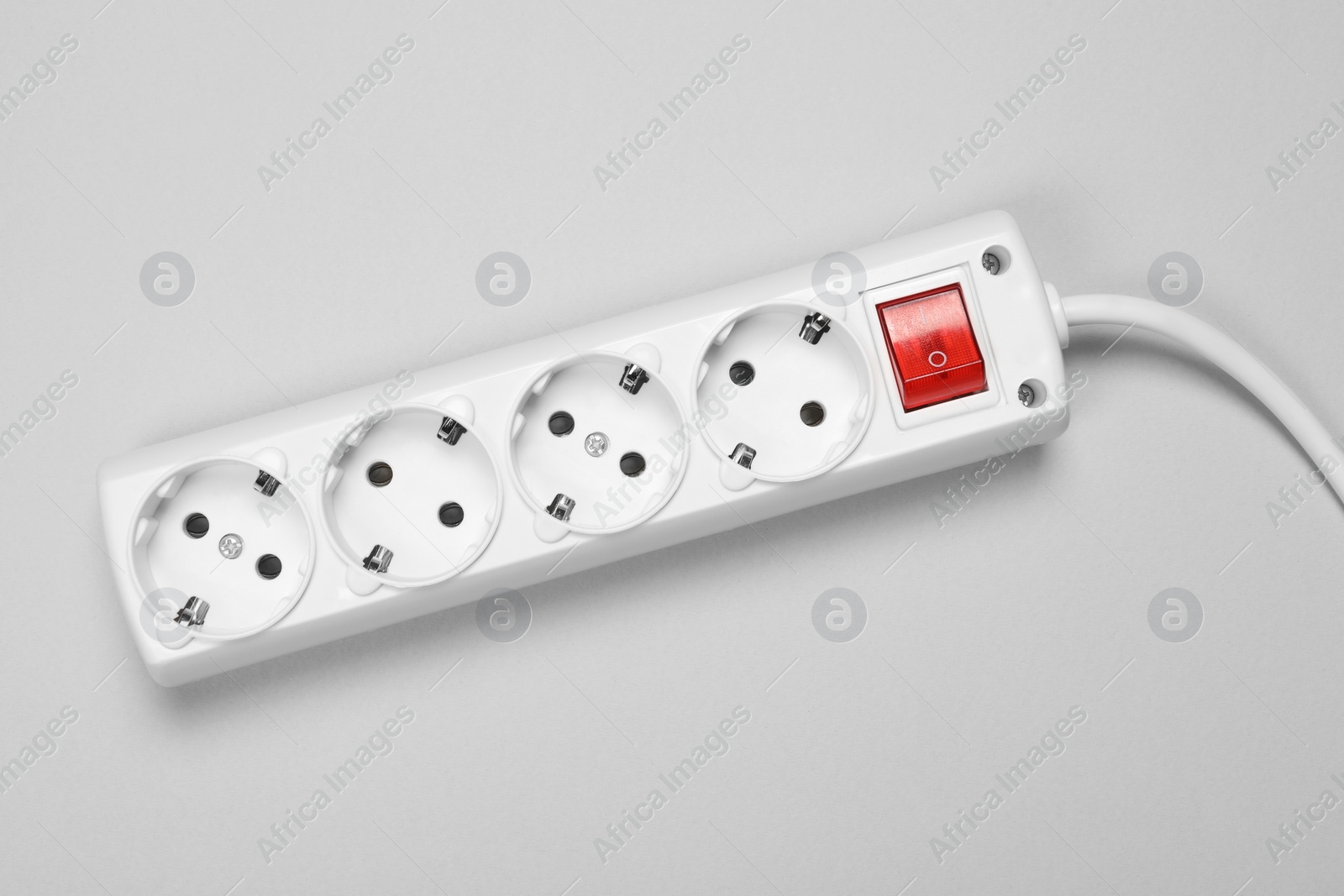 Photo of Power strip with switch button on white background, top view