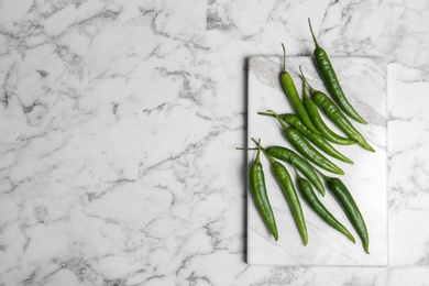 Flat lay composition with chili peppers on marble background