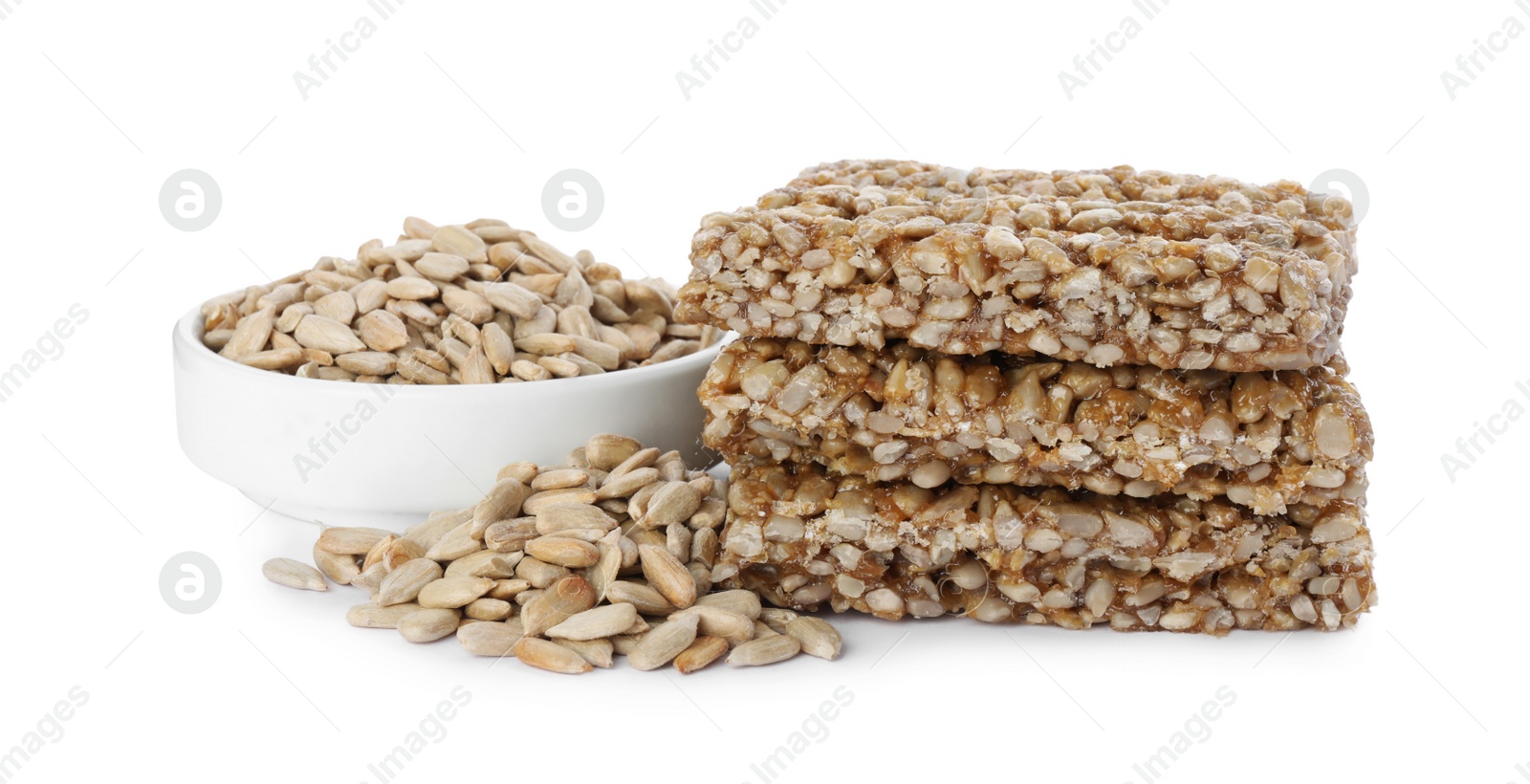 Photo of Delicious sweet kozinaki bars and sunflower seeds on white background