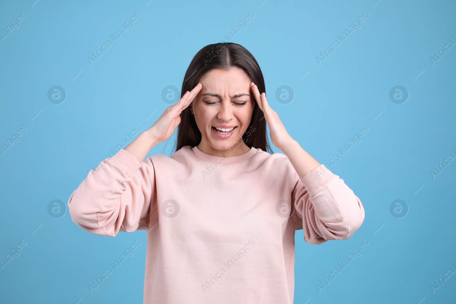 Photo of Portrait of stressed young woman on light blue background