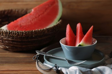 Photo of Fresh juicy watermelon and fork on wooden table, closeup. Space for text