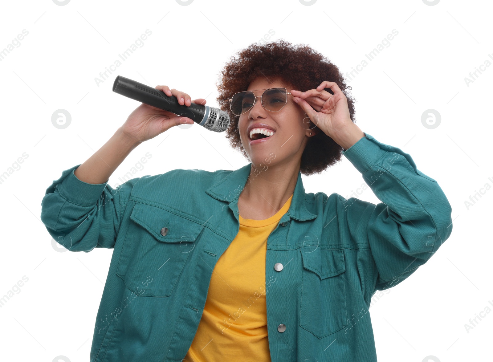 Photo of Curly young woman in sunglasses with microphone singing on white background