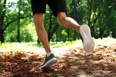 Photo of Man running in park, closeup. Morning exercise