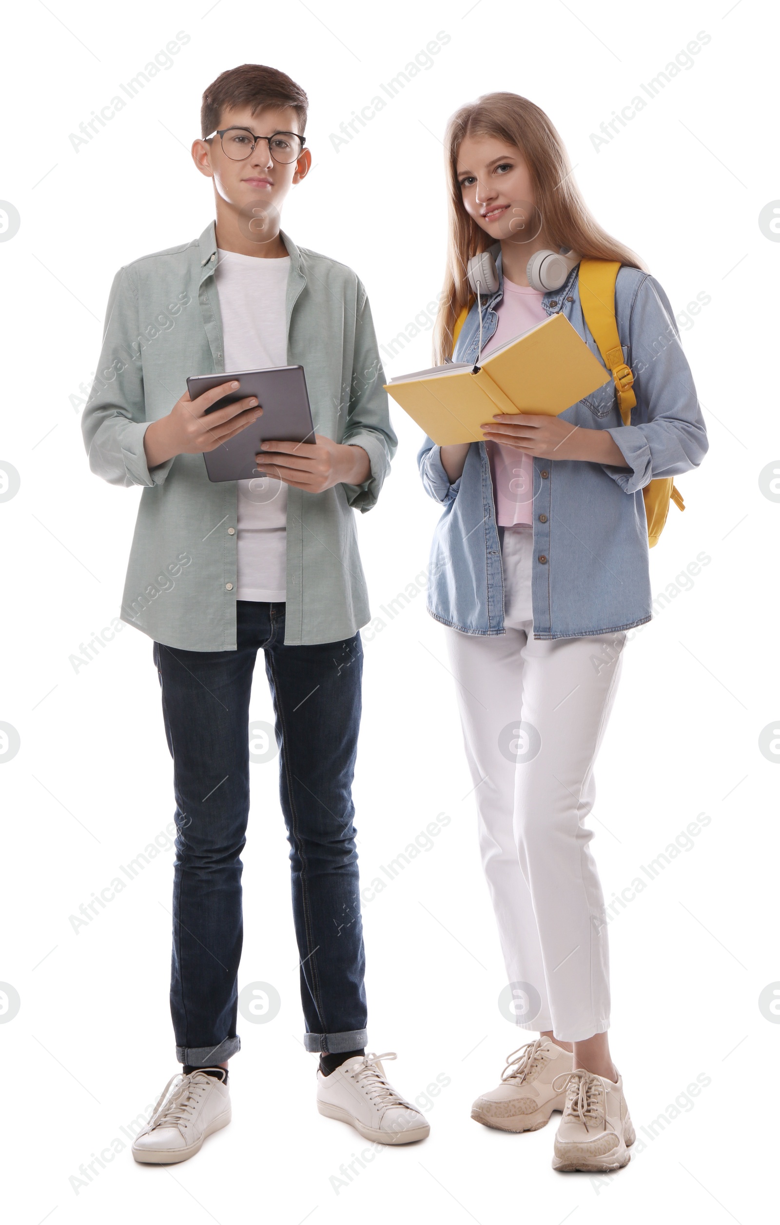 Photo of Teenage students with book and tablet on white background