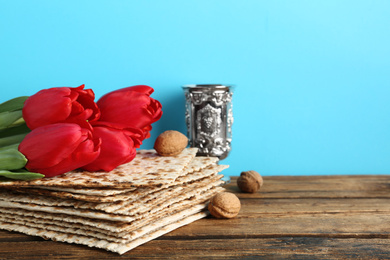 Photo of Composition with Passover matzos on wooden table, space for text. Pesach celebration