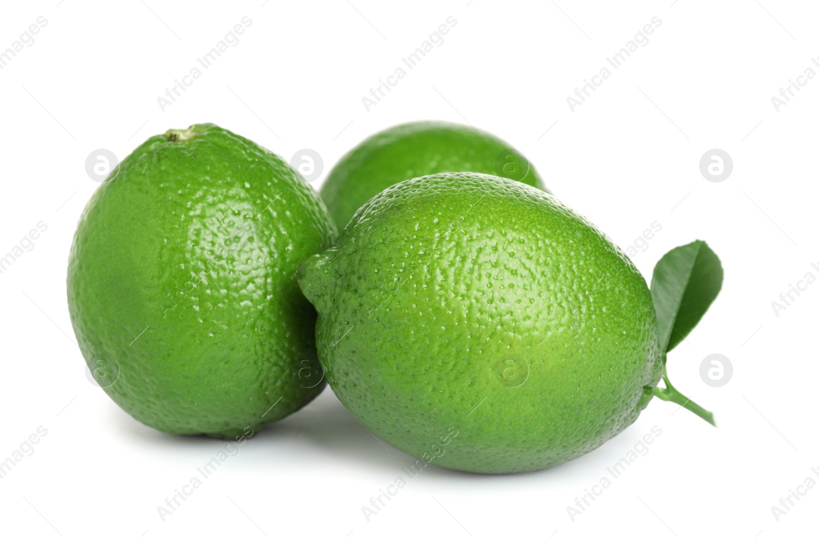 Photo of Fresh ripe limes with green leaf isolated on white