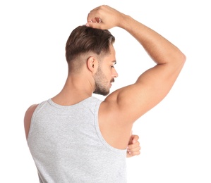 Photo of Young man showing armpit on white background. Using deodorant