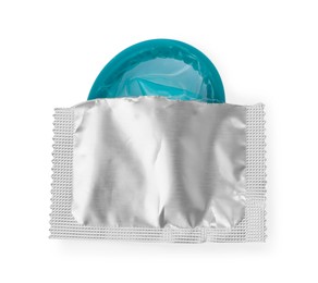 Photo of Condom in torn package on white background, top view. Safe sex