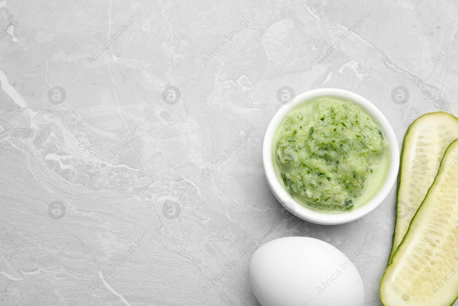 Photo of Handmade face mask and fresh ingredients on light marble table, flat lay. Space for text