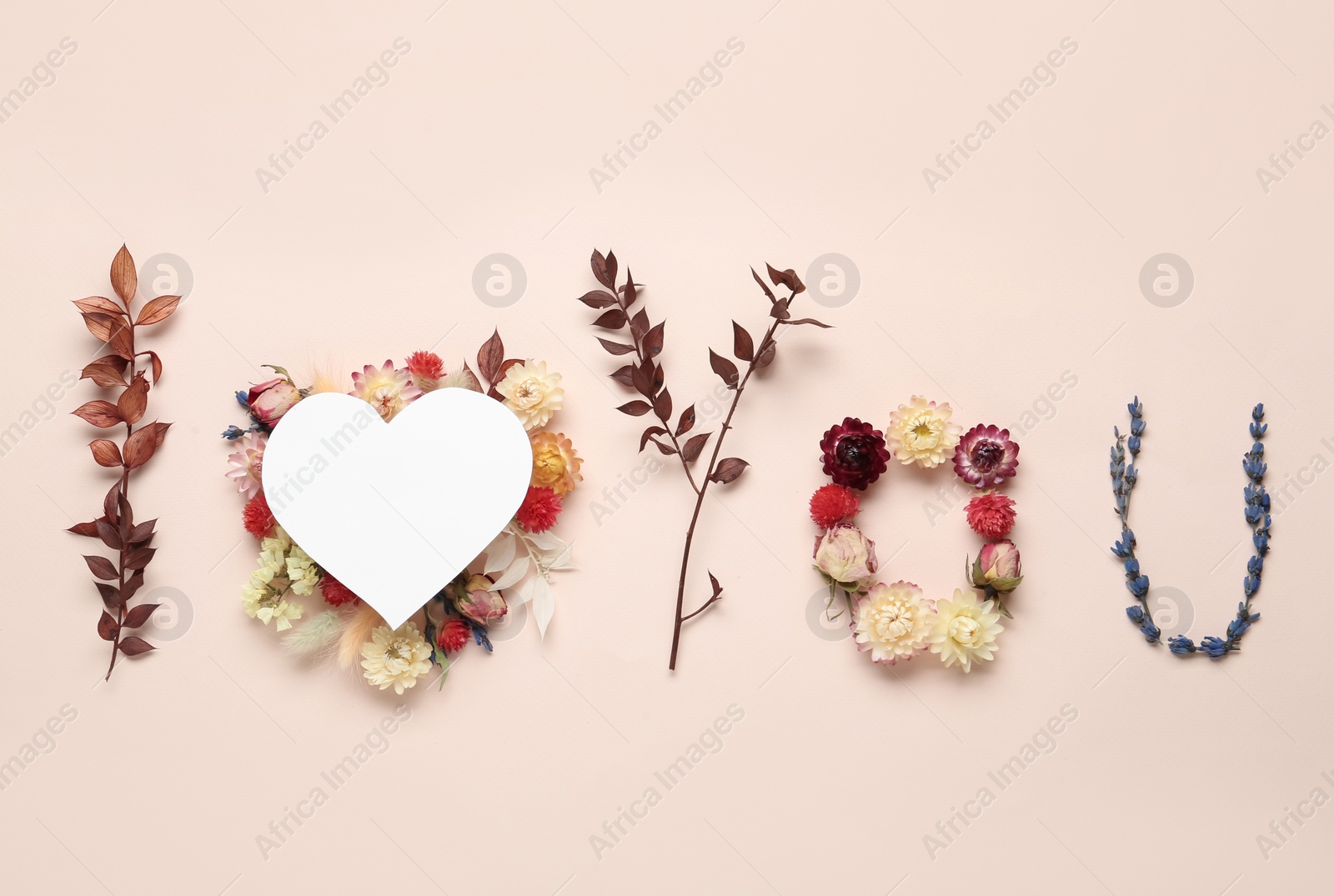 Photo of Phrase I Love You made of flowers and paper heart on beige background, flat lay